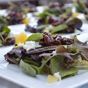 Plated Mixed Greens Beet Salad with goat cheese and candied walnuts