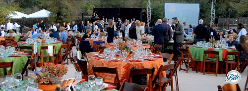 Fundraising dinner with tables, screen, and band