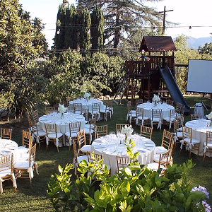 Dinner tables in lovely backyard setting