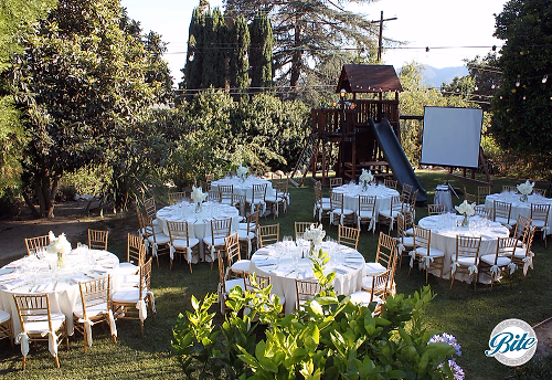 Dinner tables in lovely backyard setting