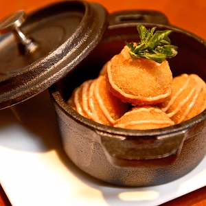 Croquettes displayed in cast iron serving pot