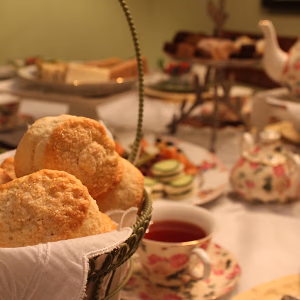 Scones in Basket on Table with Classic Tea Service