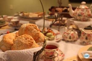 Scones in Basket on Table with Classic Tea Service