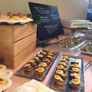 Brunch on display w/ eggs and bacon, mini breakfast basket,melon and mozzarella spoons, and mini french toast 