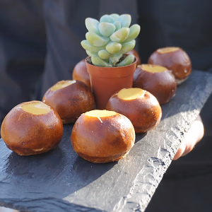 Pretzel canapes w/ cheese fondue and server in black