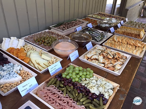 Buffet Table with Highlighted Hearty Platters on Wooden Trays