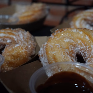 Churros with dipping sauce on display
