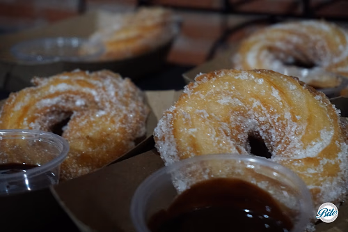 Churros with dipping sauce on display
