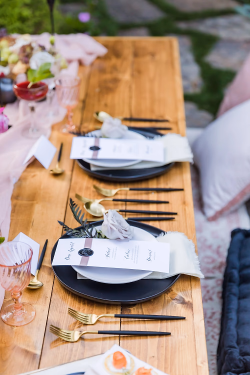 Black, gold and pink wedding tablescape with custom gold utensils and printed menu