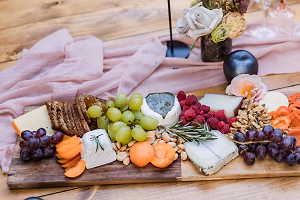 An elegant California cheese board with farmer's market accompaniments
