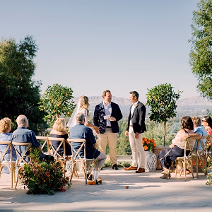 The bride and groom say their vows in front of an intimate gathering of closest friends and family in the bride's backyard of her family home in Woodland Hills