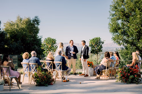 The bride and groom say their vows in front of an intimate gathering of closest friends and family in the bride's backyard of her family home in Woodland Hills
