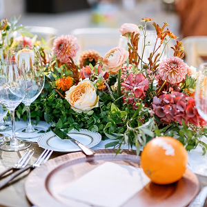 Summer florals burst with color on the wedding reception table