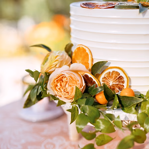 Simply perfect citrus and floral garnished custom buttercream wedding cake