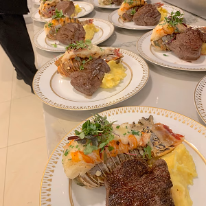 A luxurious steakhouse inspired menu to include sous vide filet mignon and butter-poached lobster tail