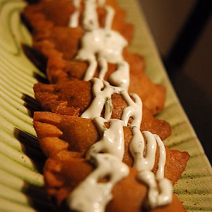 Delicious beef empanada with cilantro-lime crema