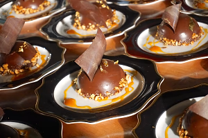 Chocolate passion fruit dome with edible gold décor and hazelnuts