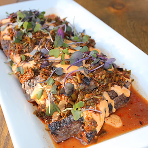 seared thinly-sliced cassis and red wine marinated flank steak with housemade chimichurri with sriracha aioli