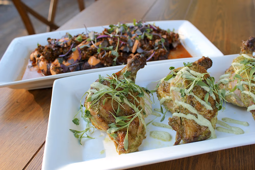 free-range cilantro-ginger airline chicken with a roasted jalapeno-lime crema and seared thinly-sliced cassis and red wine marinated flank steak with housemade chimichurri with sriracha aioli