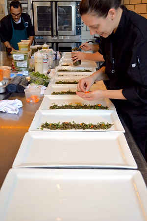 Chefs plating for family-style service