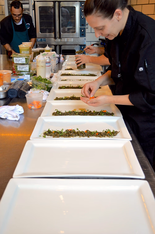 Chefs plating for family-style service