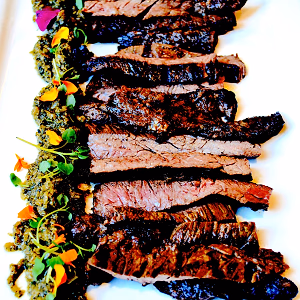 salt and pepper sliced seared skirt steak  with habanero chimichurri and micro cress