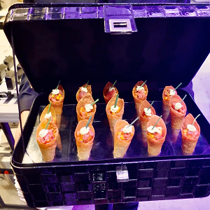 Tuna poke served in cones, passed in a briefcase serving tray