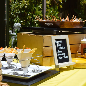 Carnival themed station with fries in handheld cones, mini corn dogs, and mac'n cheese