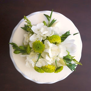 Elegant white wedding cake with green and white floral decor