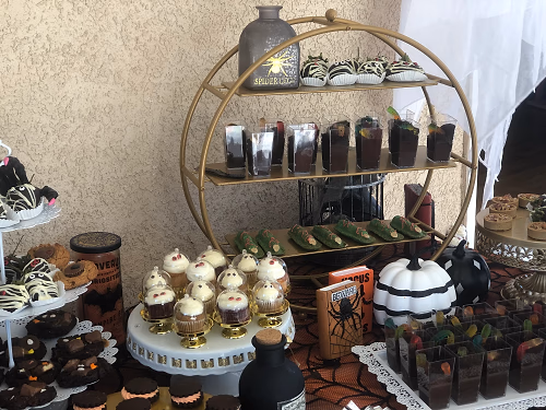A Halloween dessert bar with mini autumn pies, mummy berries, dirt cups, ghost cupcakes, and gooey butter cake bars!