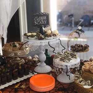 A Halloween dessert bar with mini autumn pies, mummy berries, dirt cups, ghost cupcakes, and gooey butter cake bars!