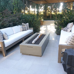 Seated area with white sofas and a modern fireplace