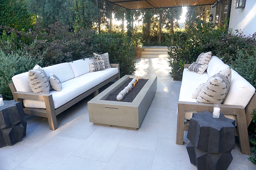 Seated area with white sofas and a modern fireplace