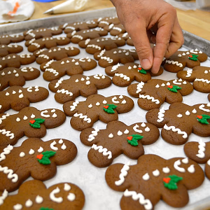 Our pastry chef putting the finishing touches on a holiday tradition - our adorable gingerbread men are ready to party!