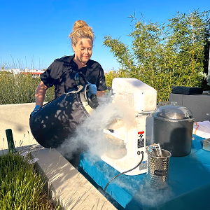 Chef preparing fresh ice cream using liquid nitrogen