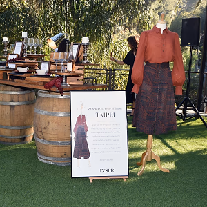 Fashion Collection Displayed Amongst Food and Wine