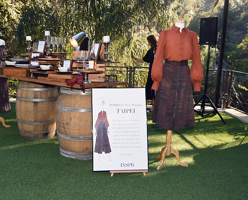 Fashion Collection Displayed Amongst Food and Wine