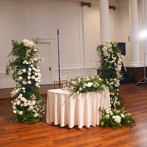Sweetheart Table framed by Floral-Covered Arches