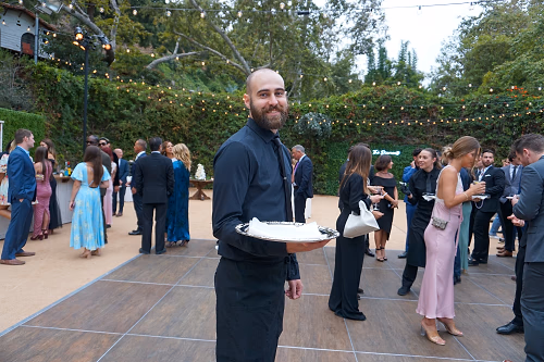 Server Passing in an Outdoor Event