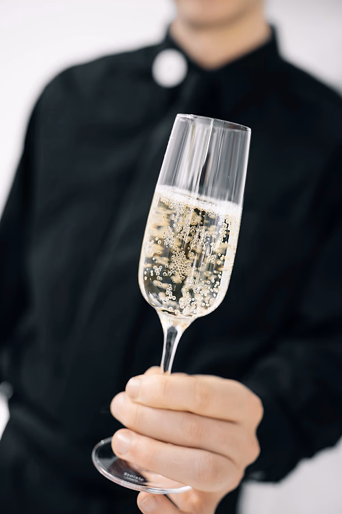 Server Handing Glass of Champagne