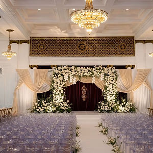 Indoor Wedding Setup with Floral Arch and Drape in Grand Ballroom