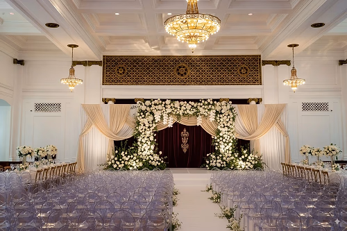 Indoor Wedding Setup with Floral Arch and Drape in Grand Ballroom