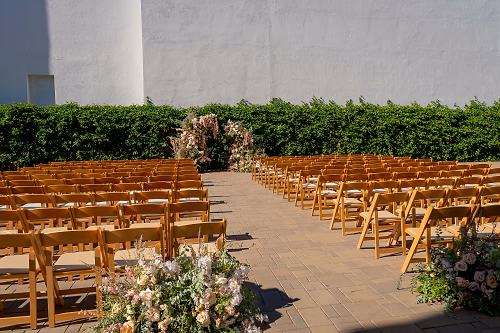 Outdoor Wedding Ceremony Setup with Large Floral Broken Arch